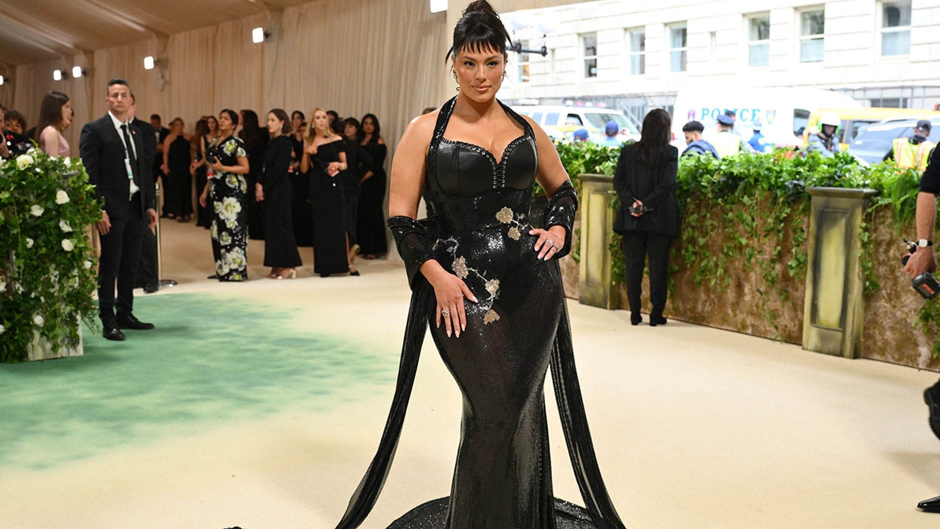 Supermodel Ashley Graham wears black leather dress to Met Gala.