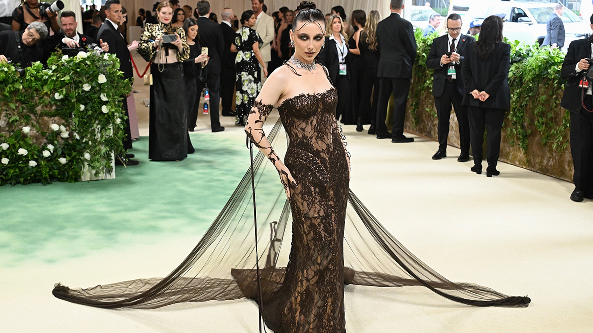 Actress Emma Chamberlain wore an off-the-shoulder brown lace dress to the 2024 Met Gala.