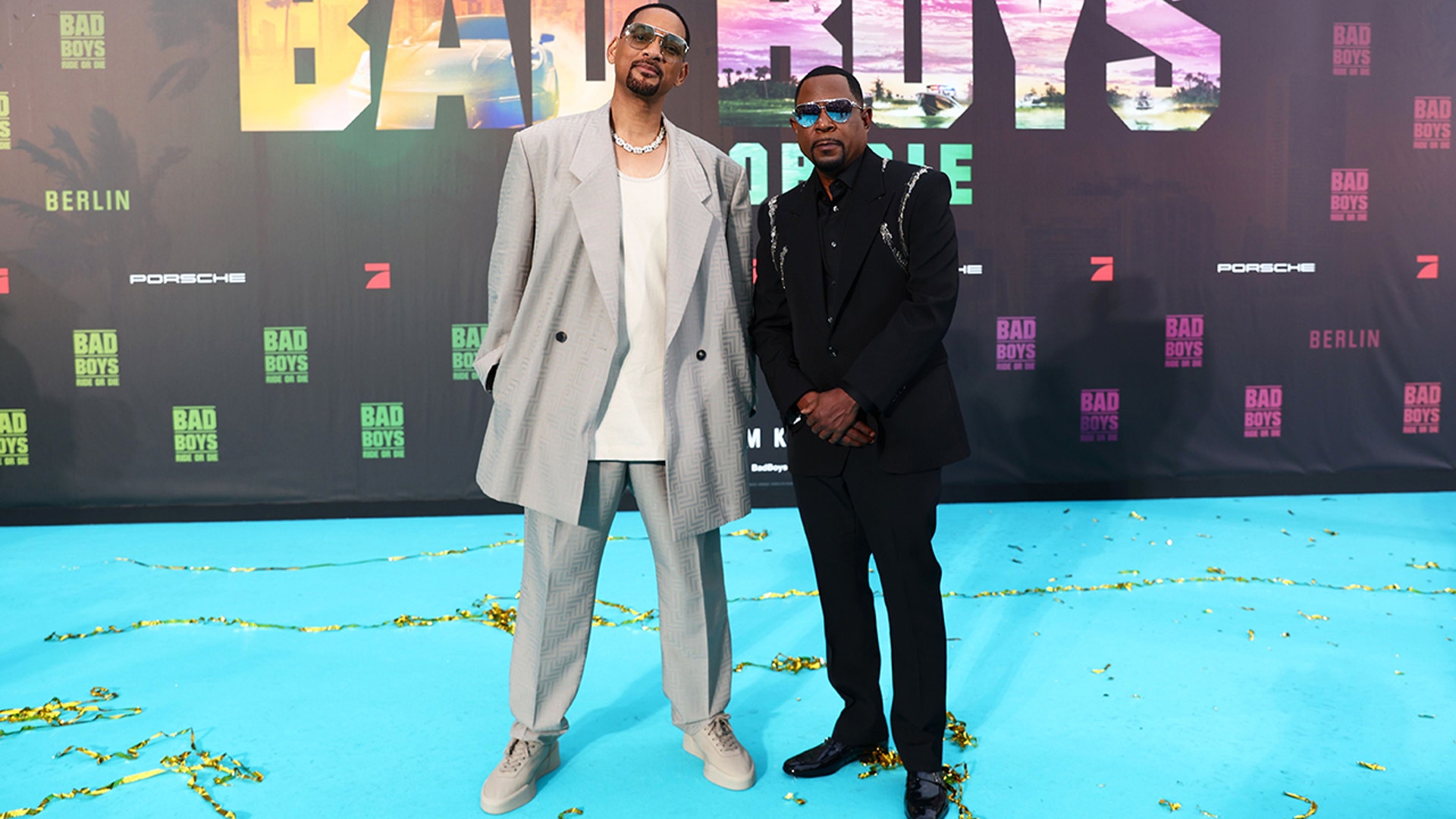 Will Smith and Martin Lawrence posed for pictures together at the premiere of "Bad Boys: Ride or Die." Lawrence wore a black suit with embelishments on the shoulders, while Smith wore a gray suit with an oversized jacket.