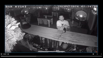 Security cam catches drunken thief celebrate bar heist with bottle of bubbly
