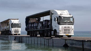 Aid starts entering Gaza through land after US ‘floating pier’ damaged by weather