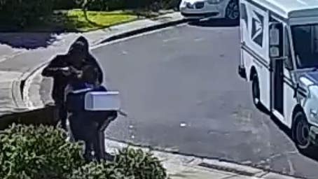 Postal worker robbed at gunpoint in brazen daytime attack caught on video