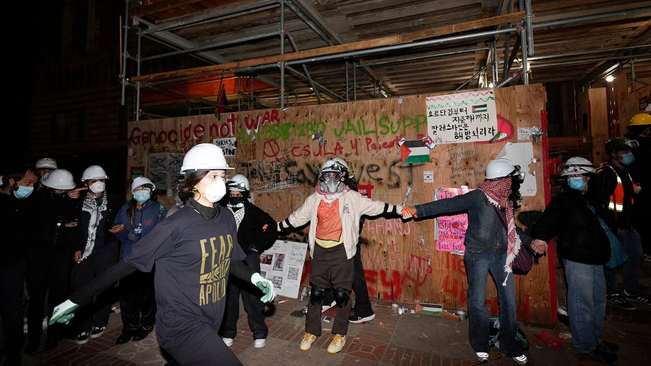 Anti-Israel agitators in helmets and masks at UCLA