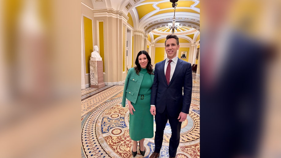 Dawn Chapman wearing a green dress and Sen. Josh Hawley wearing a suit and tie