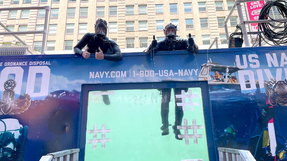 two navy divers in the dive tank