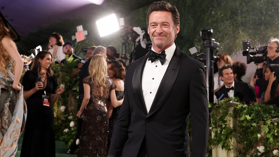Hugh Jackman at the Met Gala 2024 red carpet in a black Tom Ford tuxedo.