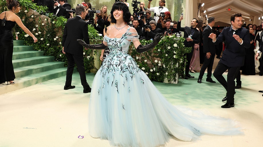 Sydney Sweeney at the Met Gala 2024 red carpet in a powder blue gown and black hair.