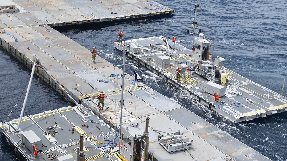 US military constructs hulking metal pier amid Biden’s $320 million gamble to get aid into Gaza