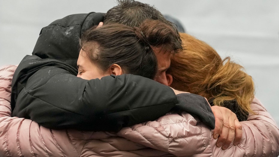 Flowers, candles, silence as Serbia marks the 1st anniversary of mass shooting at a Belgrade school