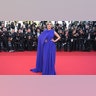 Andie Macdowell walked the red carpet at the Cannes Film Festival in a blue gown with a dramatic cape flowing down her right arm.