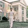 Elvis Presley standing outside of Graceland.