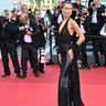 Bella Hadid attended the premiere of "L’Amour Ouf" in Cannes, France in a black Versace gown, wearing her hair in big curls.