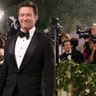 Hugh Jackman at the Met Gala 2024 red carpet in a black Tom Ford tuxedo.