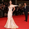 Demi Moore at the Cannes Film Festival in a champagne gown with a dramatic wing.