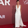 Demi Moore stunned on the amfAR Gala red carpet in a white satin dress with crystal embroidery, a plunging neckline and long train.