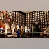 A room with elvis' costumes and records displayed for fans
