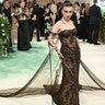 Actress Emma Chamberlain wore an off-the-shoulder brown lace dress to the 2024 Met Gala.