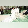 Kris Jenner at the Met Gala 2024 red carpet in a white satin gown and overcoat designed by Oscar de la Renta. with Chris Gamble who wore an all white suit.