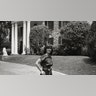 Priscilla Presley standing outside Graceland.