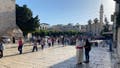 A church processions sings hymns as it passes through Bethlehem and enters the Church of the Nativity.