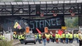 Farmers block the border between Spain and France with a huge banner during a demonstration demanding better conditions ahead of European elections, in Irun, Spain, on June 3, 2024.