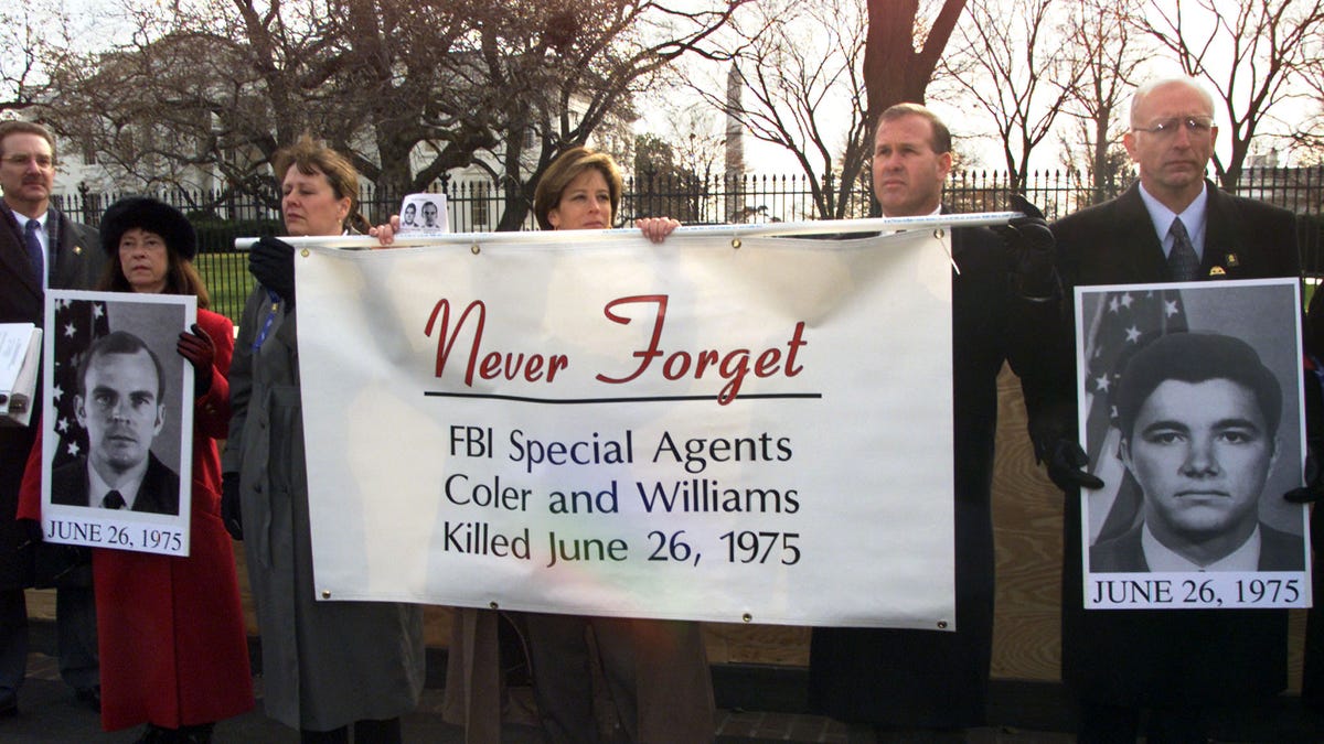 FBI Agents hold a banner in front of the White House
