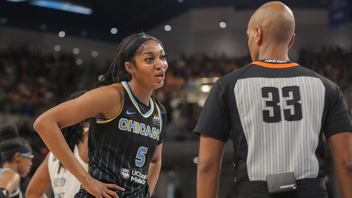 Angel Reese talks to a referee