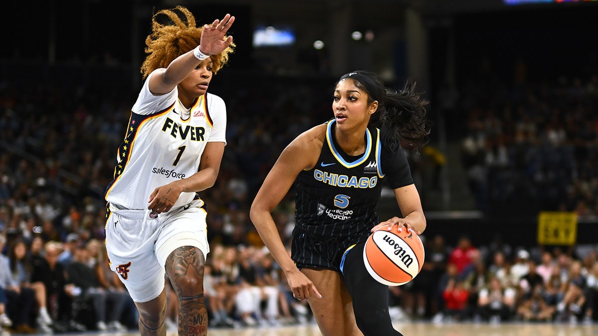 Angel Reese of the Chicago Sky drives the ball past NaLyssa Smith of the Indiana Fever during the first half at Wintrust Arena on June 23, 2024, in Chicago.