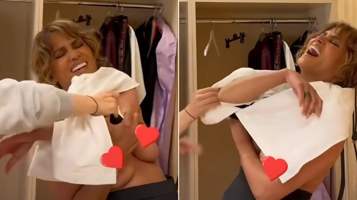 Halle Berry en dos fotos intenta ponerse la camiseta por encima de la cabeza con corazones rojos cubriéndole la zona de las tetas