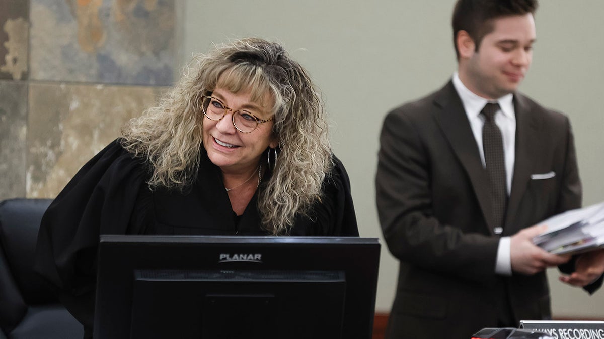 Judge Mary Kay Holthus smiles in the courtroom