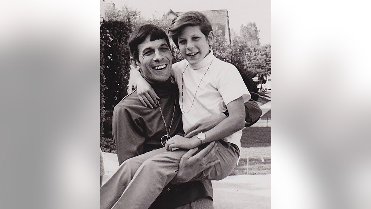 Leonard Nimoy holding up his son Adam.