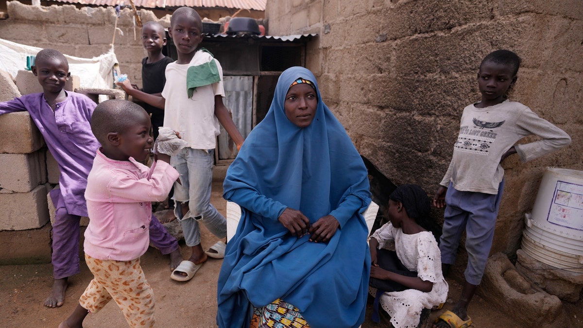 Aisha Aliyu, 36-year-old mother of five, is photographed with her children in Kaltungo Poshereng Nigeria