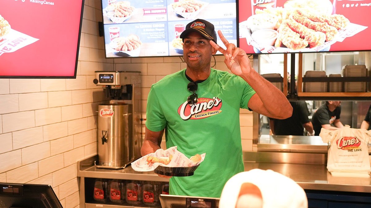 Al Horford with peace sign behind Raising Cane's counter