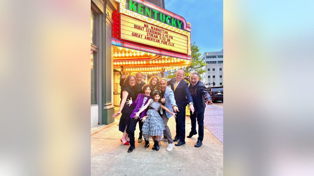 Alexa and Carlos PenaVega outside a theater with people