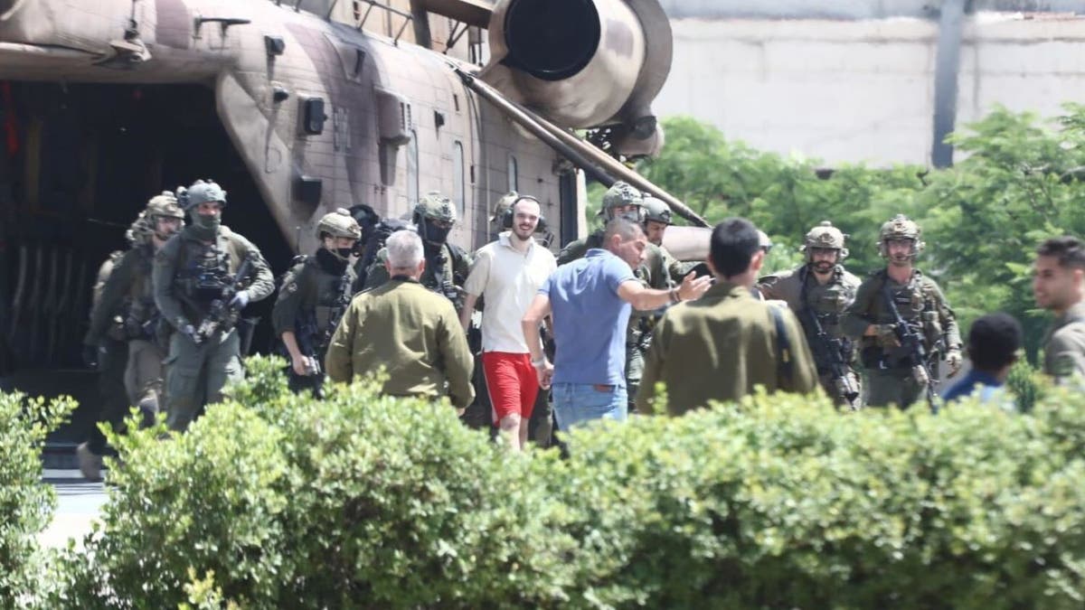 Andrey Kozlov walking out of a helicopter after being rescued from Hamas