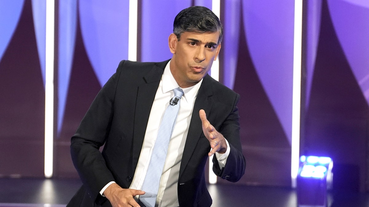 British Prime Minister Rishi Sunak appears in a suit and tie on a stage as he speaks during a BBC Question Time Leaders' Special in York, England.