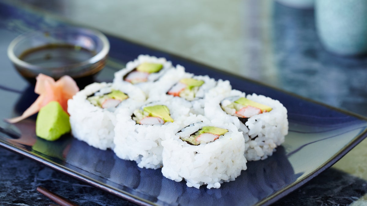 A plate containing a California roll is shown.