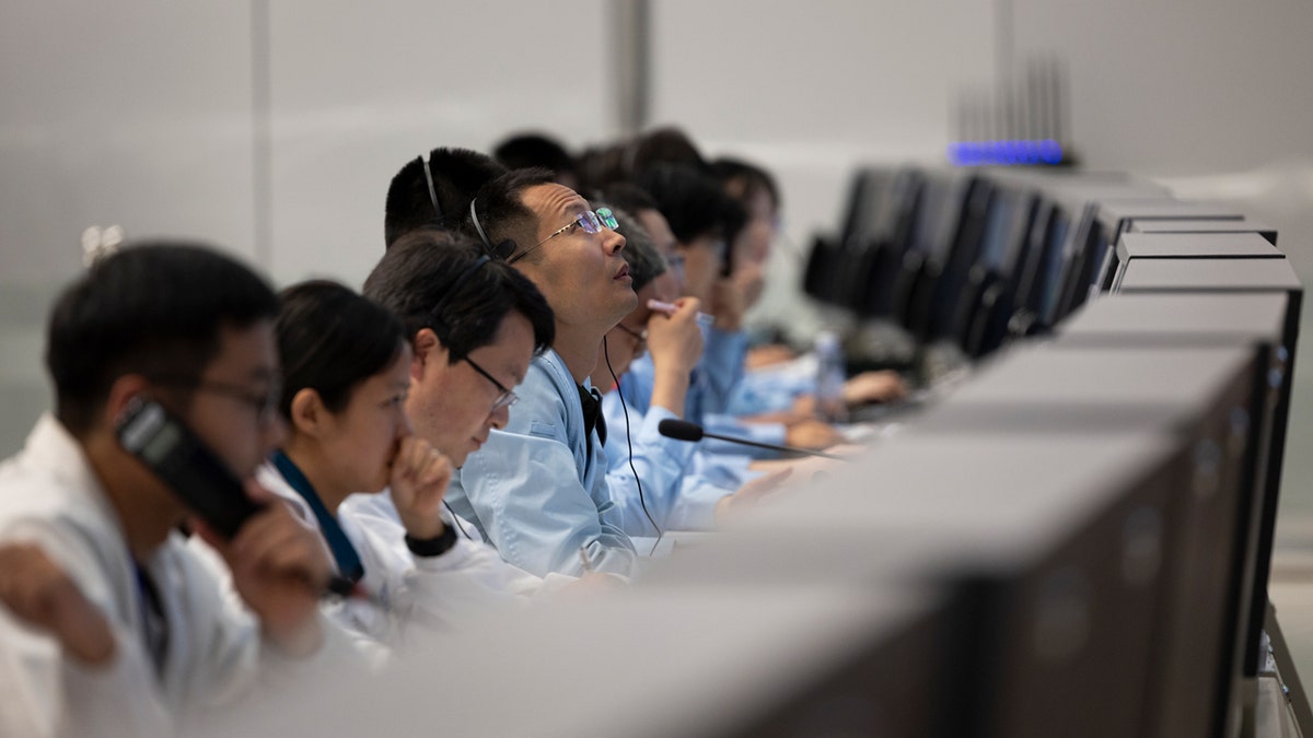 Technical personnel work at a row of computers at the Beijing Aerospace Control Center in Beijing, on June 2, 2024.