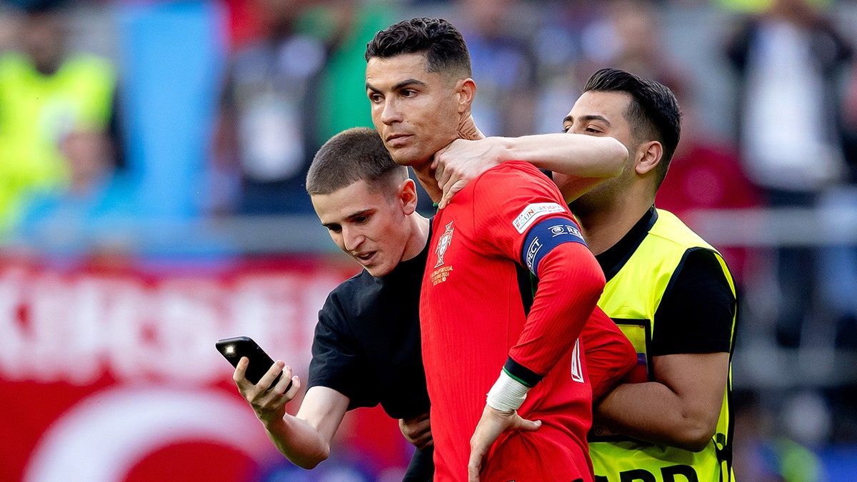 Cristiano Ronaldo with fan around his neck