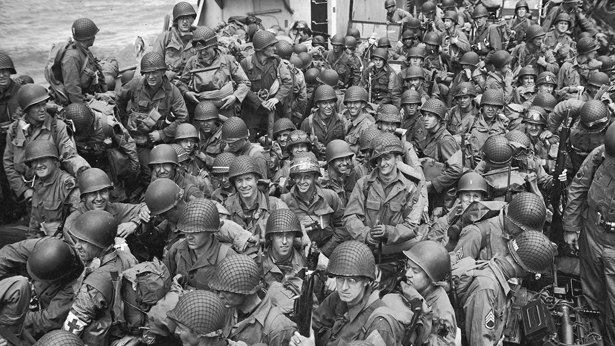 U.S. Army troops flock to naval infantry landing craft during the D-Day Invasion of Normandy