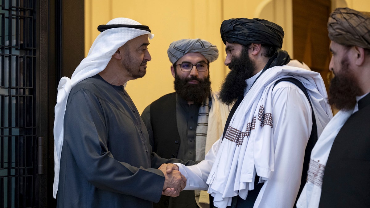 Emirati leader Sheikh Mohammed bin Zayed Al Nahyan, ruler of Abu Dhabi, left, shakes hands with Taliban official Sirajuddin Haqqani, right, at Qasr Al Shati palace in Abu Dhabi, United Arab Emirates.