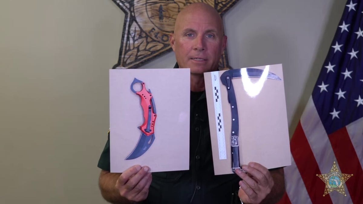 Sumter County Undersheriff Pat Breeden showing photos of the murder weapons