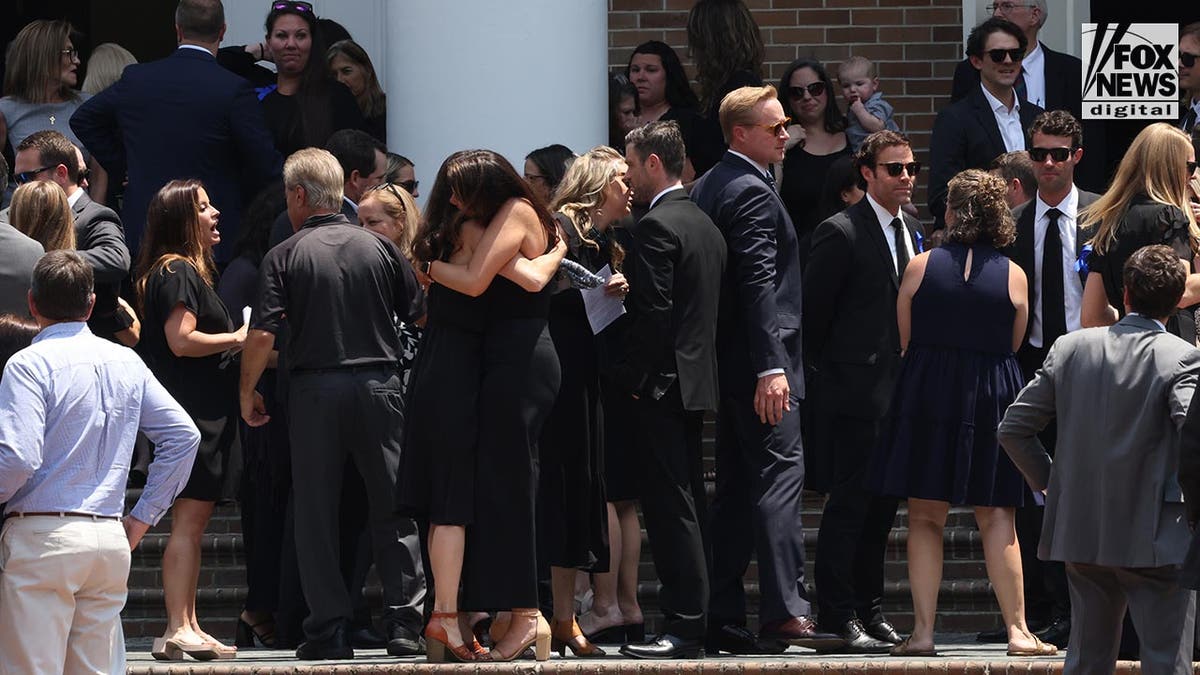People attend a funeral at a church for Johnny Wactor