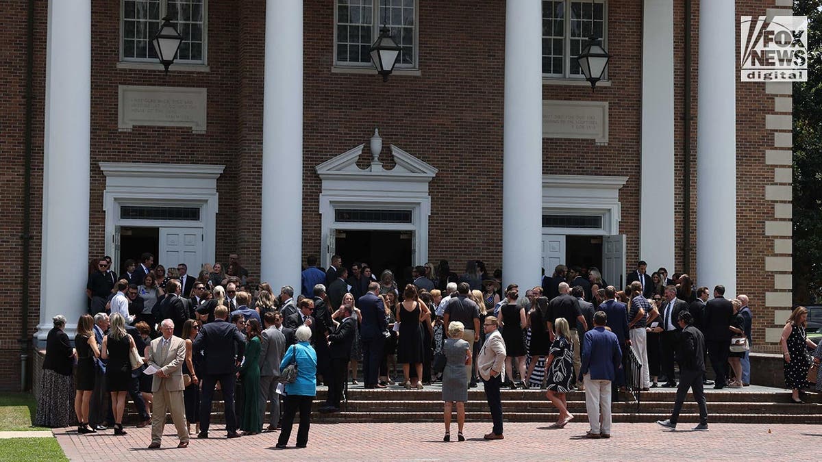 People attend a funeral at a church for Johnny Wactor