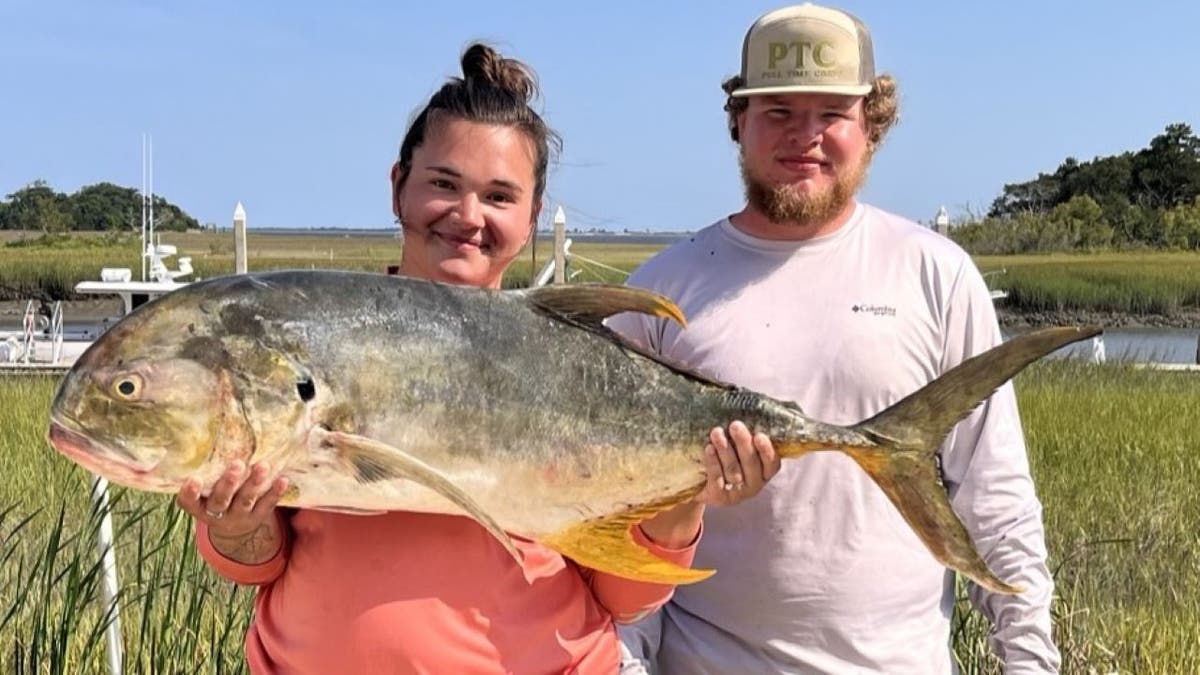 Woman holding huge fish