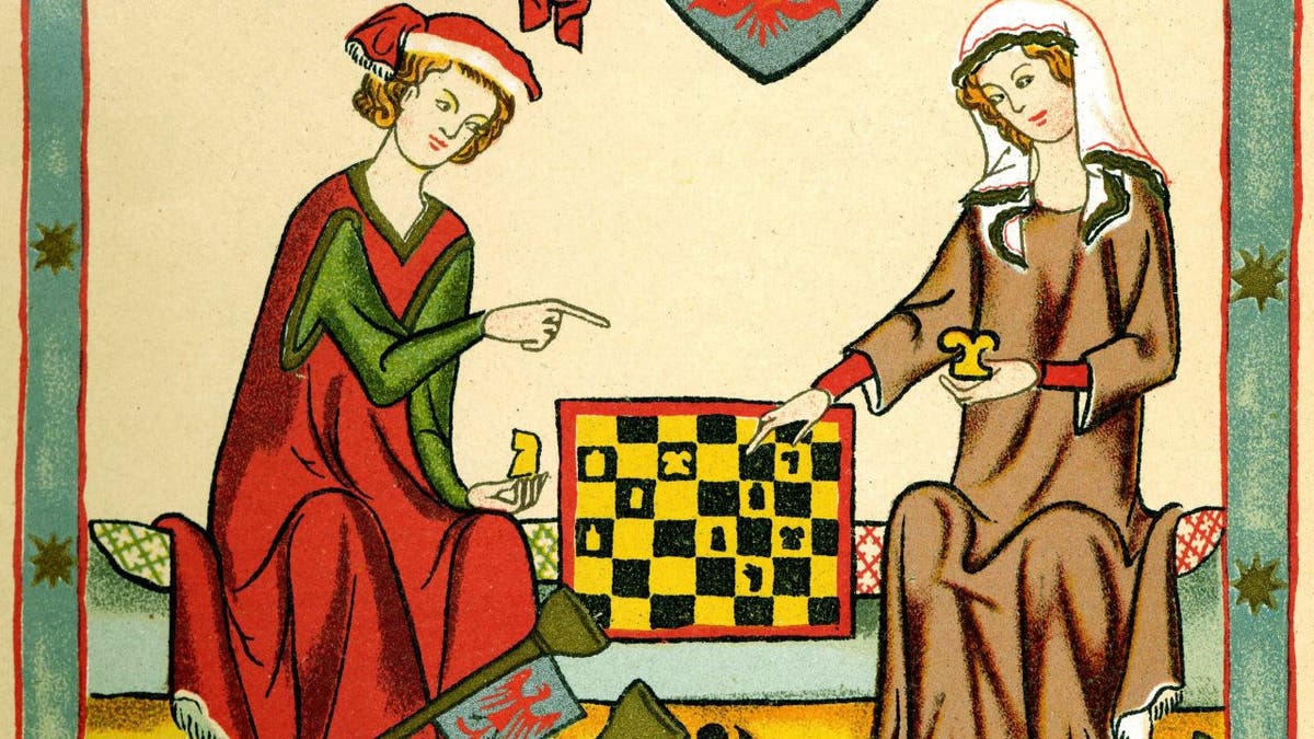 Medieval man and woman playing chess