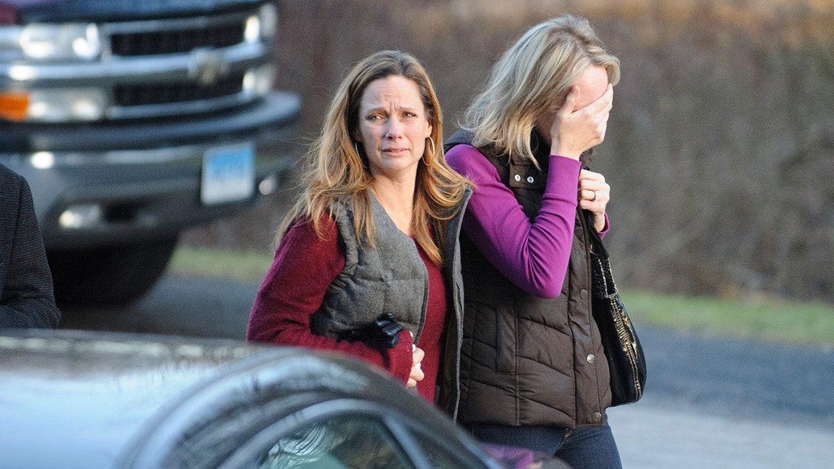 sandy hook parents walk away from the scene of the shooting