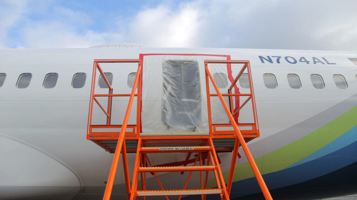 plastic covers the exterior of the fuselage plug area of Alaska Airlines Flight 1282 Boeing 737-9 MAX
