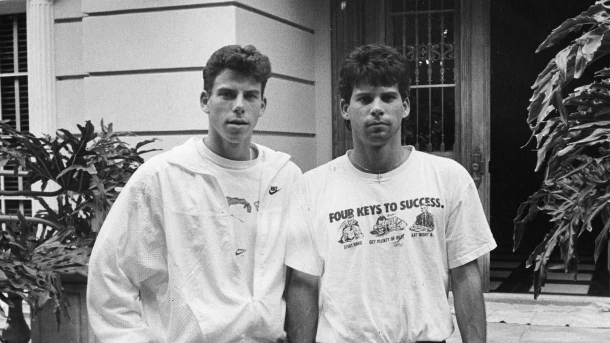 The Menendez Brothers in a black and white photo outside their Beverly Hills home