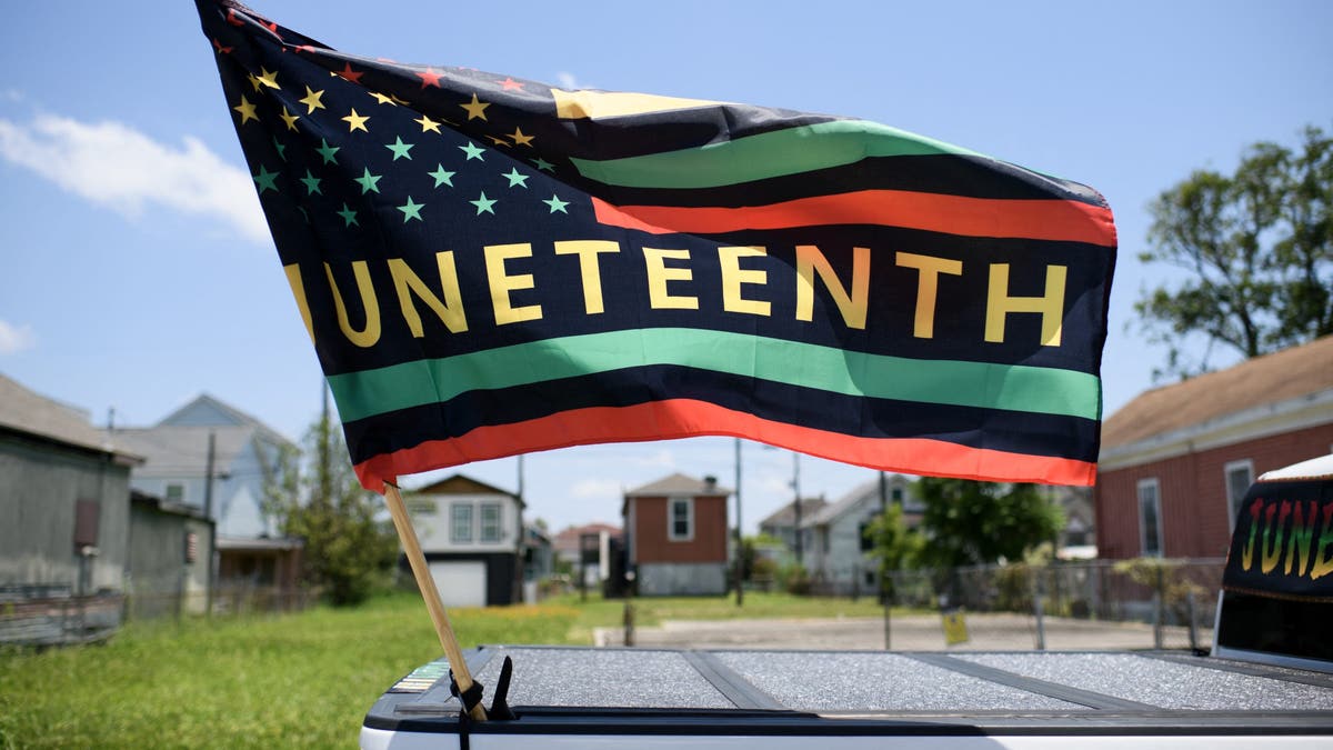 A Juneteenth flag flies on a float during the 45th annual Juneteenth National Independence Day celebrations in Galveston, Texas, on June 15, 2024. Juneteenth falls on June 19 and has often been celebrated on the third Saturday in June, to mark the end of slavery in the US. (Photo by Mark Felix / AFP) (Photo by MARK FELIX/AFP via Getty Images)